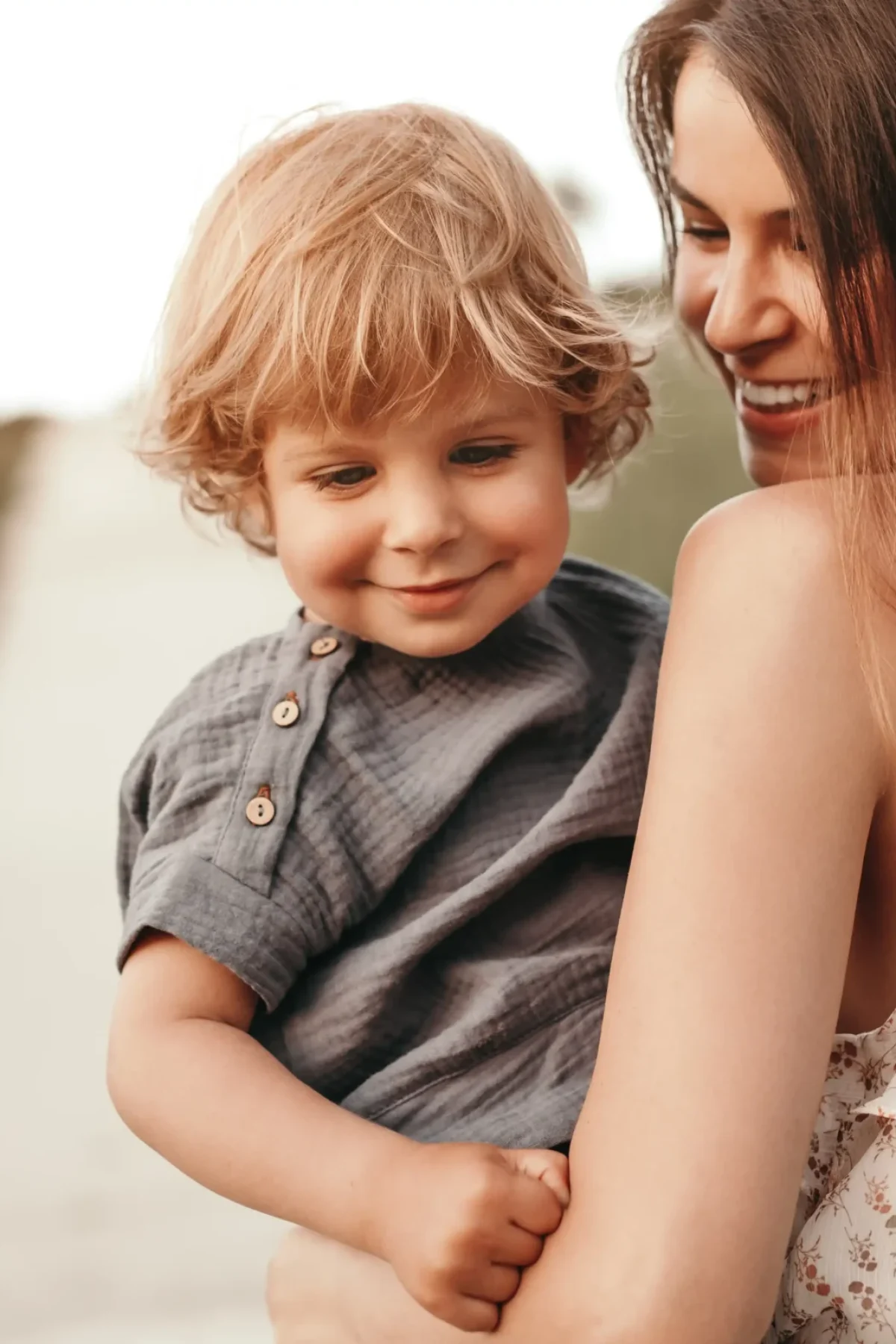 woman-holds-a-toddler-along-a-grassy-path-2026-03-25-00-21-31-utc